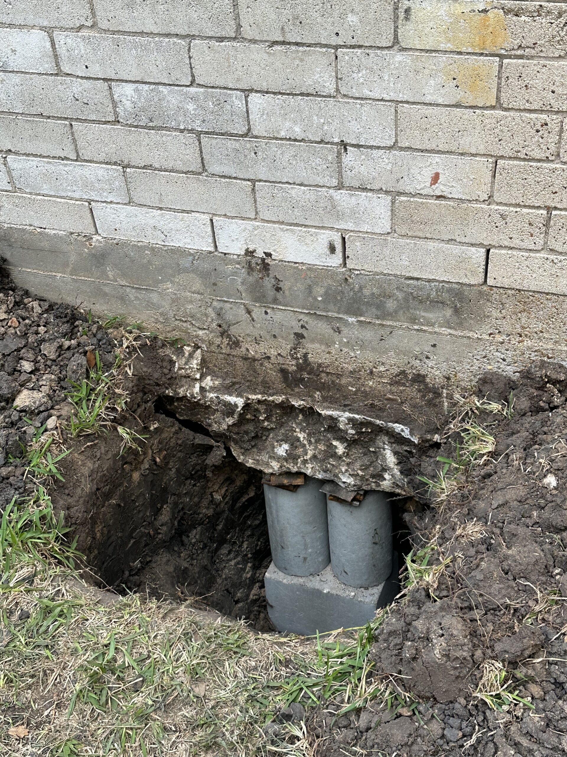 Driven concrete piers supporting a building foundation